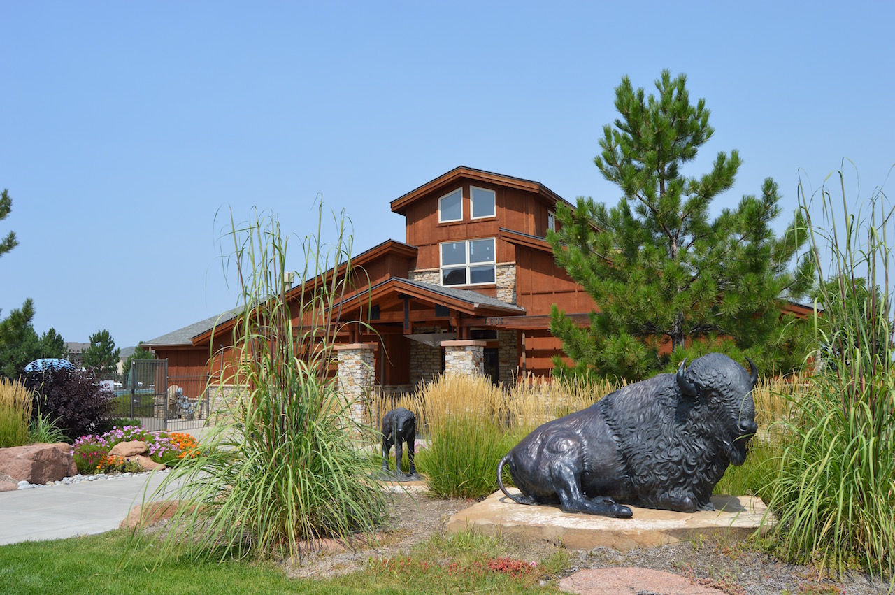 exterior of Wheatlands Clubhouse with rustic architecture.
