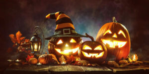 Spooky smiling jack-o-lanterns on a dark background.