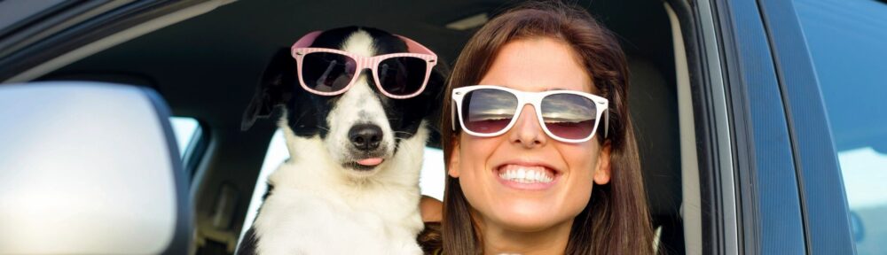 Girl with sunglasses in car with dog with sunglasses