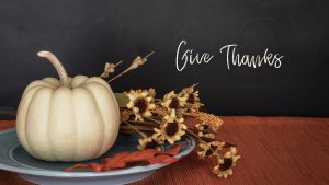 pumpkin and flowers with words "Give Thanks"