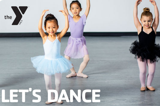 The little girls dancing in ballet tutus on a gray studio floor.