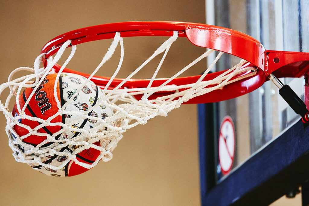 Close up of basketball swishing into the basket.