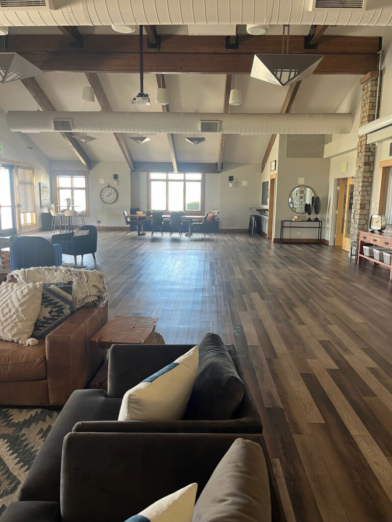 Interior of Wheatlands clubhouse with a sitting area and meeting tables in the background.