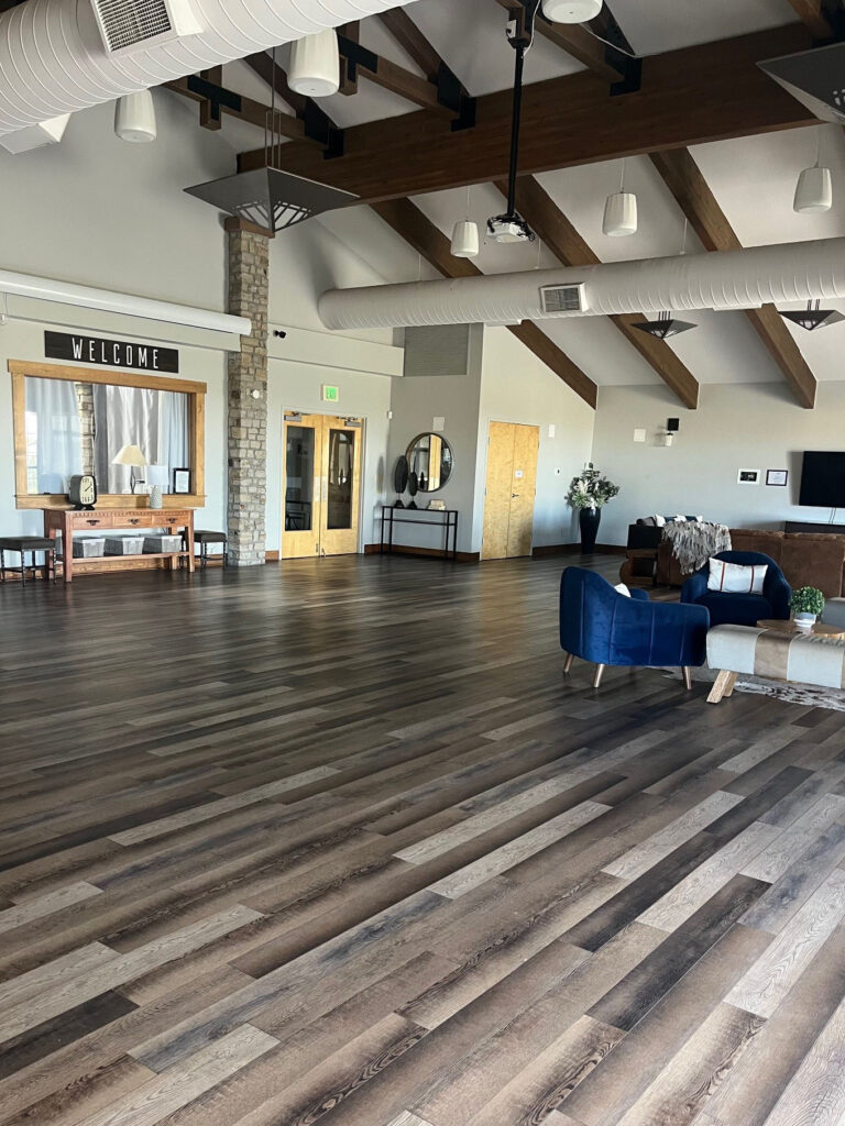 Interior view of clubhouse with sitting area and high-beamed ceiling.