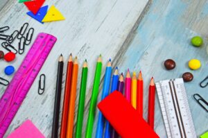 school supplies on painted table background