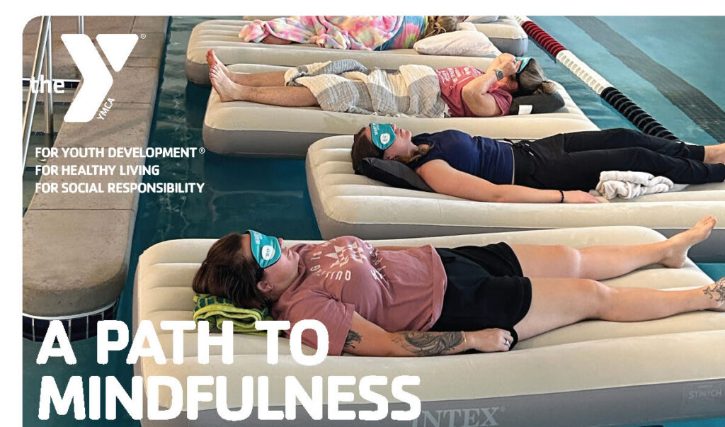 A group of people lying on air mattresses with eye masks during a sound bath class.