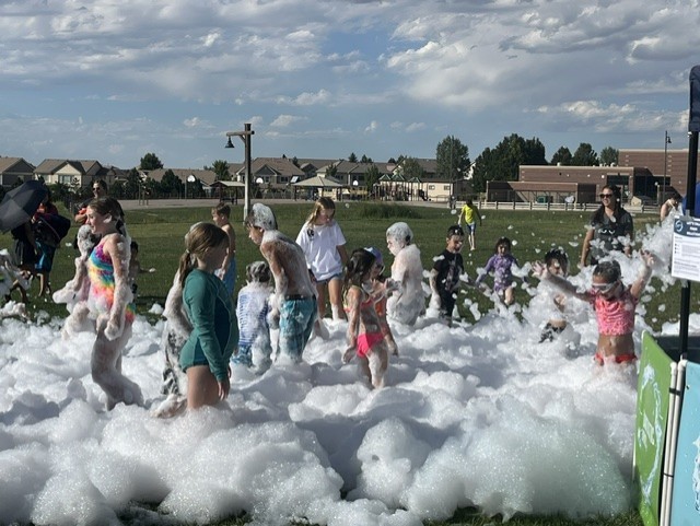 kids and adults playing in foam at a party